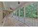 Relaxing screened porch with wood flooring and a view of the backyard, offering an inviting outdoor living space at 216 Pondside Dr, Apex, NC 27539