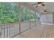 Spacious screened porch featuring ceiling fans, offering a cool and comfortable retreat with views of the lush backyard at 216 Pondside Dr, Apex, NC 27539