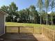 Wood deck view of the expansive, tree-lined backyard at 233 Constellation Ct, Benson, NC 27504