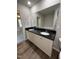 Bathroom featuring a double vanity with black countertops and wood-look floors at 233 Constellation Ct, Benson, NC 27504