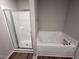 Bathroom with a glass-enclosed shower and a separate soaking tub at 233 Constellation Ct, Benson, NC 27504