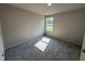 Well lit bedroom featuring plush carpeting and a large window at 233 Constellation Ct, Benson, NC 27504