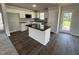 Modern kitchen featuring stainless steel appliances, granite countertops, and an island at 233 Constellation Ct, Benson, NC 27504