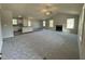 Open-concept living room and kitchen area with fireplace, island, and modern finishes at 233 Constellation Ct, Benson, NC 27504