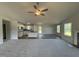 Open-concept living room and kitchen area with fireplace, island, and modern finishes at 233 Constellation Ct, Benson, NC 27504