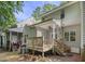 The back of this home boasts a spacious wooden deck with stairs to the backyard at 2623 Broad Oaks Pl, Raleigh, NC 27603