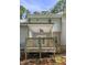 View of the back deck featuring wood railings, covered area, and brick paver accents at 2623 Broad Oaks Pl, Raleigh, NC 27603