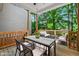 Back porch with a table and chairs as well as a lounge area at 2623 Broad Oaks Pl, Raleigh, NC 27603