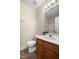Bathroom features neutral walls, a wooden vanity, and wood-look vinyl plank flooring at 2623 Broad Oaks Pl, Raleigh, NC 27603