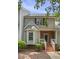 Inviting townhome with brick facade, white trim, and well-manicured front yard at 2623 Broad Oaks Pl, Raleigh, NC 27603