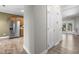 Hallway view showing laminate floors leading to kitchen with stainless refrigerator at 2623 Broad Oaks Pl, Raleigh, NC 27603