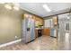 Kitchen features stainless appliances, including a fridge, and wood cabinets at 2623 Broad Oaks Pl, Raleigh, NC 27603