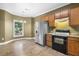 Bright kitchen features stainless steel refrigerator and wooden cabinets at 2623 Broad Oaks Pl, Raleigh, NC 27603