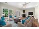 Stylishly staged living room with fireplace, hardwood floors, and lots of light at 2623 Broad Oaks Pl, Raleigh, NC 27603