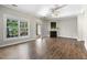 Bright living room featuring hardwood floors, a fireplace, and access to the outdoor deck at 2623 Broad Oaks Pl, Raleigh, NC 27603