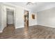 View of living area with hard wood floors, ceiling fan, entry doors, and kitchen access at 2623 Broad Oaks Pl, Raleigh, NC 27603