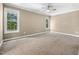 Spacious carpeted main bedroom offers neutral paint and ample natural light from multiple windows at 2623 Broad Oaks Pl, Raleigh, NC 27603