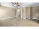 Neutral carpeted main bedroom with ceiling fan and access to the ensuite bathroom and walk-in closet at 2623 Broad Oaks Pl, Raleigh, NC 27603