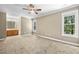 Spacious main bedroom features carpet, ceiling fan, neutral paint, and ensuite bathroom access at 2623 Broad Oaks Pl, Raleigh, NC 27603