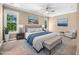 Staged main bedroom with neutral paint, carpet, ensuite bathroom, and accent art at 2623 Broad Oaks Pl, Raleigh, NC 27603
