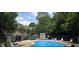 Community pool with lounge chairs and a backdrop of mature trees at 2623 Broad Oaks Pl, Raleigh, NC 27603