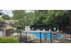 Community pool with lounge chairs and a backdrop of mature trees at 2623 Broad Oaks Pl, Raleigh, NC 27603