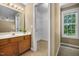 Bathroom with single sink vanity and walk-in closet with wire shelving and natural light at 2623 Broad Oaks Pl, Raleigh, NC 27603