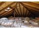 Attic featuring roof framework, insulation, ductwork and a skylight at 2710 Broad St, Durham, NC 27704