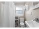 Cozy bathroom with a shower featuring a bathtub, window for natural light, and white fixtures at 2710 Broad St, Durham, NC 27704