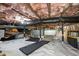 Well-maintained crawl space with white vapor barrier, insulation, and some storage at 2710 Broad St, Durham, NC 27704