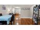 Dining room with hardwood floors, a table with chairs, and seamless view into the living room and front entryway at 2710 Broad St, Durham, NC 27704