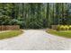 Long gravel driveway leading to wooded property offers privacy at 2710 Broad St, Durham, NC 27704