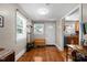 Inviting home entryway with hardwood floors, coat rack and storage bench with a view of the kitchen at 2710 Broad St, Durham, NC 27704