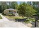 Charming home showcasing a red door, and beautiful landscaping at 2710 Broad St, Durham, NC 27704