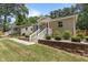 Charming homes featuring a red front door, white railings, brick foundation trim, and well-manicured lawns at 2710 Broad St, Durham, NC 27704
