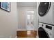 Hallway leading to a bathroom with stackable washer and dryer units, offering convenience at 2710 Broad St, Durham, NC 27704