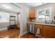 Charming kitchen with stainless steel dishwasher, tile backsplash, and hardwood floors at 2710 Broad St, Durham, NC 27704