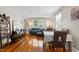 Comfortable living room and dining area with hardwood floors, a blue sofa, and natural light from the window at 2710 Broad St, Durham, NC 27704