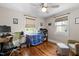Bright office space with hardwood floors, a ceiling fan, and ample natural light from two windows at 2710 Broad St, Durham, NC 27704