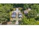 Aerial view of two homes with well manicured yards, driveways, and landscaping on a tree lined street at 2712 Broad St, Durham, NC 27704