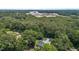 Aerial view showing a neighborhood with large trees and a distant building complex at 2712 Broad St, Durham, NC 27704