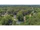 Aerial view showing a neighborhood with large trees and roadways at 2712 Broad St, Durham, NC 27704