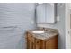 Bathroom featuring a vintage-style vanity with granite countertop and a painted brick wall at 2712 Broad St, Durham, NC 27704