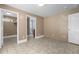 Bedroom with tile floors, doors to ensuite bath and closet and painted brick accent wall at 2712 Broad St, Durham, NC 27704