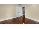 Bedroom with hardwood floors leading to a closet with white doors and a hallway at 2712 Broad St, Durham, NC 27704