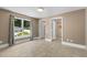 Bright bedroom with window, tile floors, and doorways to the ensuite bathroom and hallway at 2712 Broad St, Durham, NC 27704