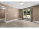 Bedroom featuring a window with yard views, tile flooring, and ample natural light at 2712 Broad St, Durham, NC 27704