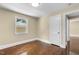 Bedroom with hardwood floors and a window with a view to the outside at 2712 Broad St, Durham, NC 27704
