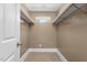 Walk-in closet with shelving and a small window for natural light at 2712 Broad St, Durham, NC 27704