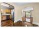 Dining room with hardwood floors and view of the kitchen featuring stainless appliances at 2712 Broad St, Durham, NC 27704